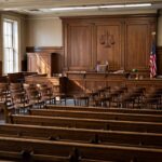 What Is Small Claims Court? A Plain-English Guide to Getting Justice Without a Lawyer Small claims courtroom interior with judge bench and empty chairs viewed from the gallery