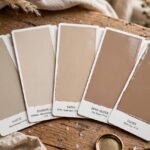 Paint swatches in different sheens from matte to gloss fanned out on a table