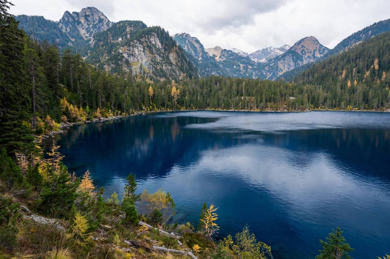 Large mountain lake with deep blue water and forested shoreline