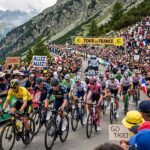 What Is the Tour de France? Stages, Jerseys & How It Works Tour de France peloton climbing a mountain pass before cheering crowds