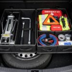 What Tools Do You Need to Change a Tire? The Complete Kit Complete tire change toolkit organized in a trunk for what tools do you need to change a tire