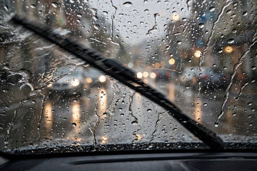 Rain on windshield with wipers running during a downpour