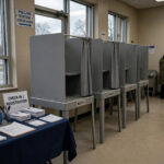 Why Is Voter Turnout Low? The Real Reasons Explained Nearly empty polling station with voting booths and few voters